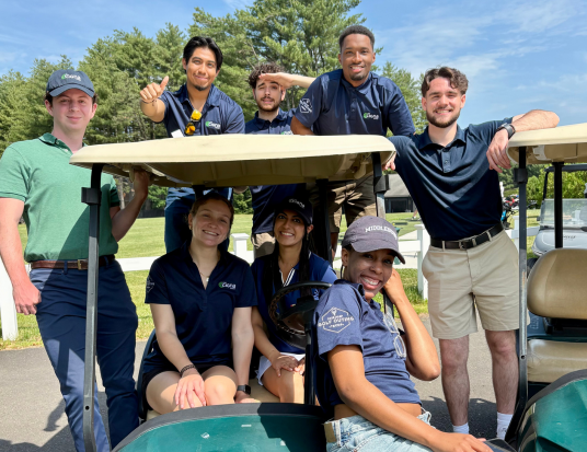 TECDP associates on a golf cart