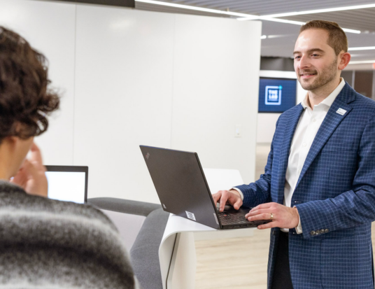 Employee standing with his laptop