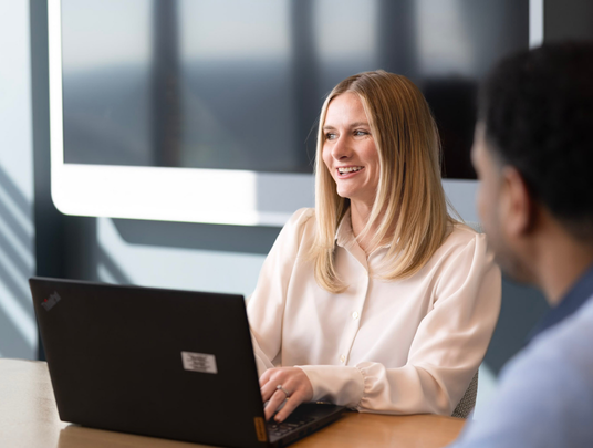 Employee smiling at laptop