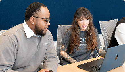 A man and a woman looking at a laptop together.