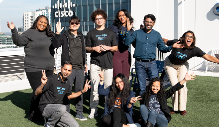 A group of smiling Cisconians at an outdoor area at a Cisco office.
