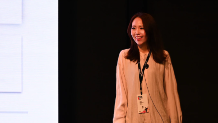 A woman presenting in a stage