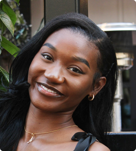 Ashlee smiles at the camera with her head tilted