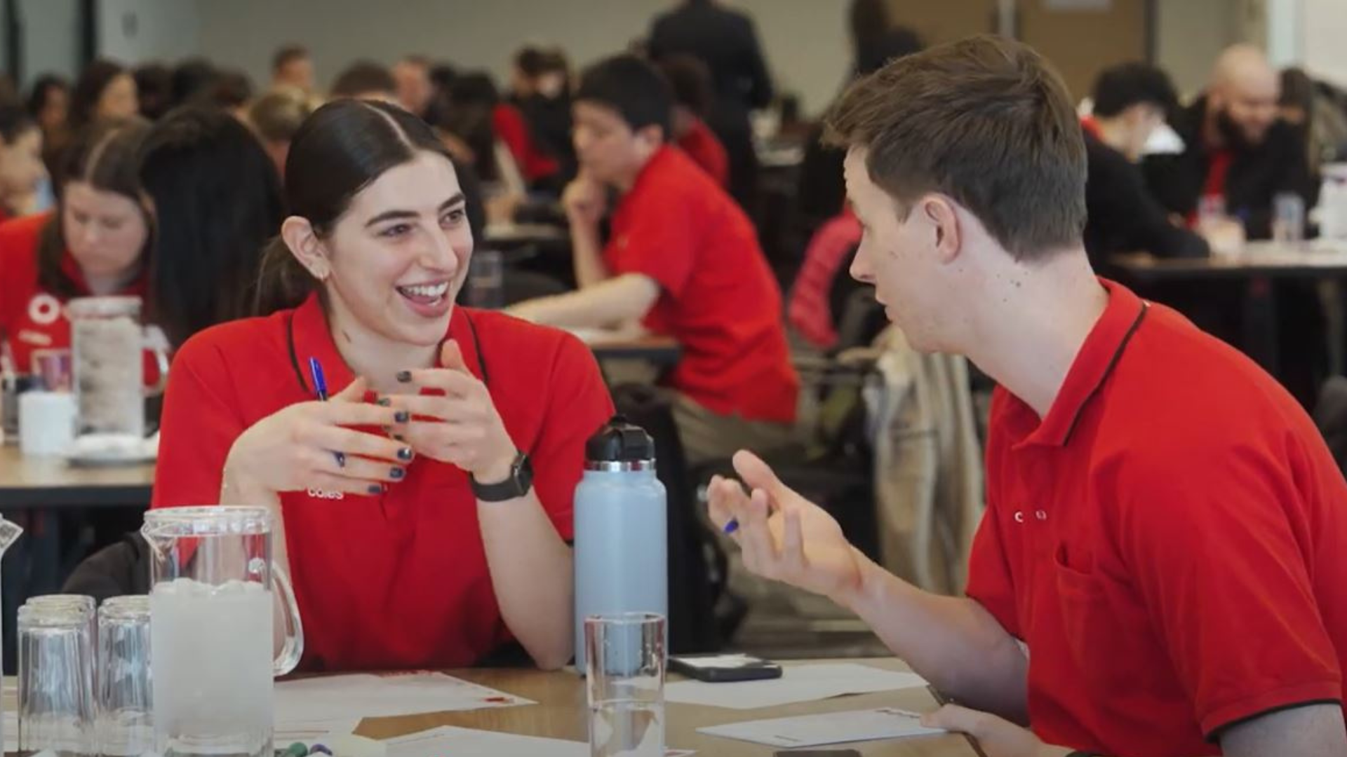 Two Coles team members sitting at a table