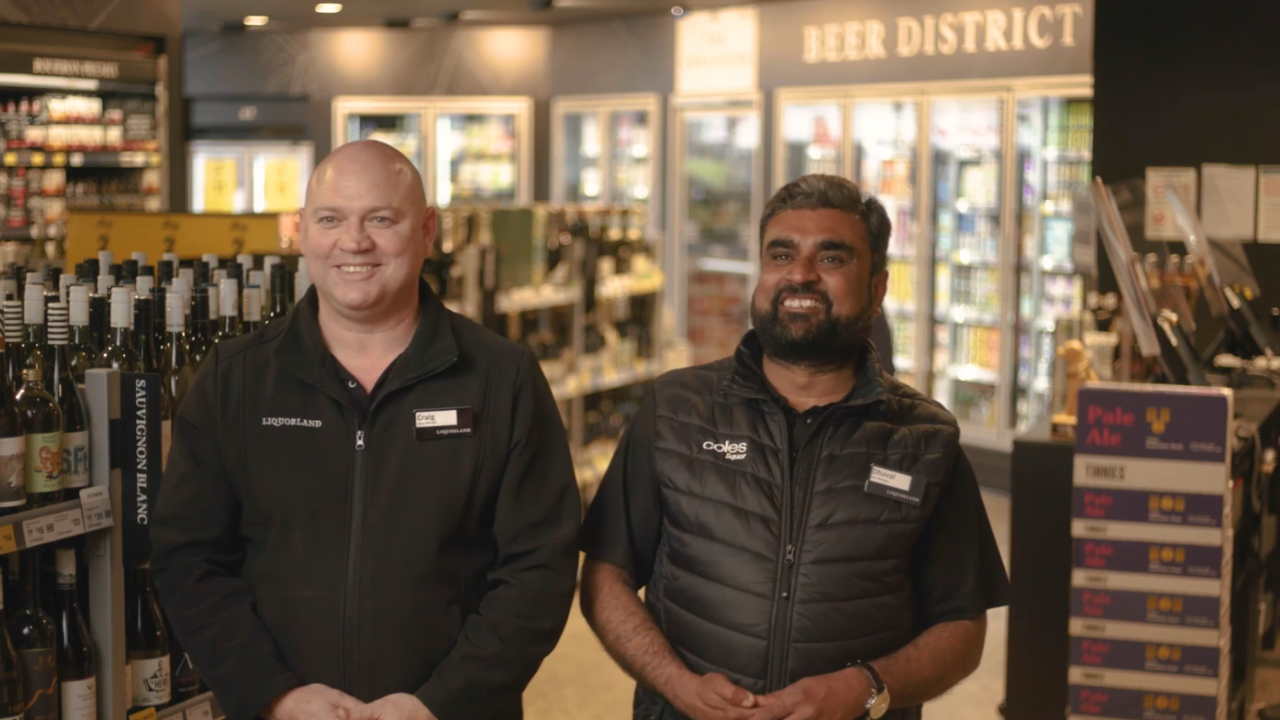 two male team members working at liquorland