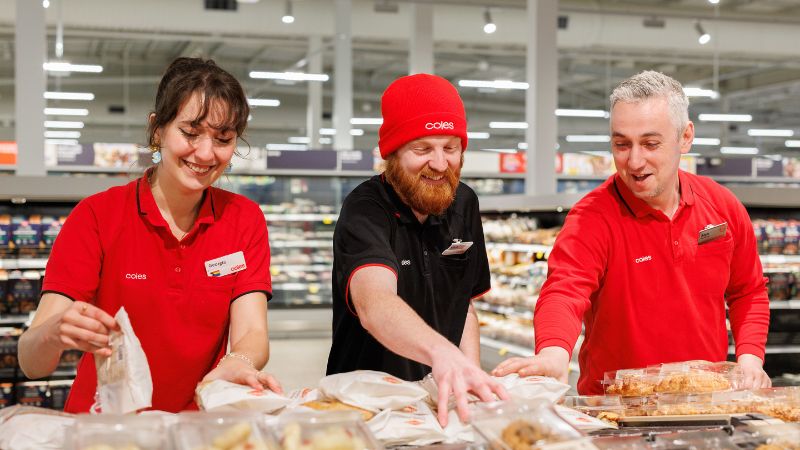 Three Coles team members working together in Bakery department