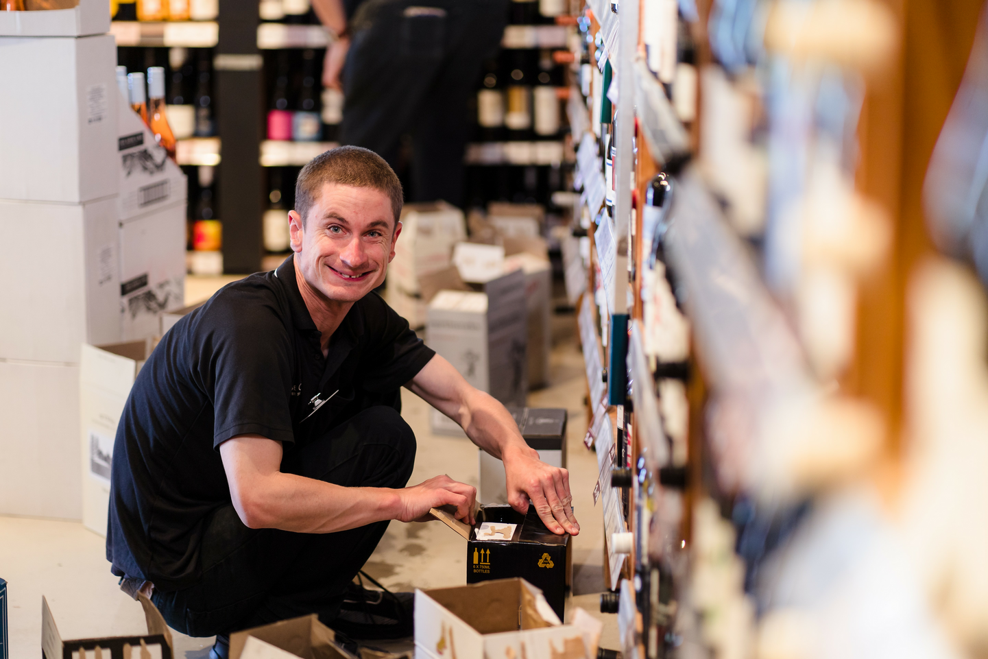 A Coles team member with a disability working at a Coles Liquor store