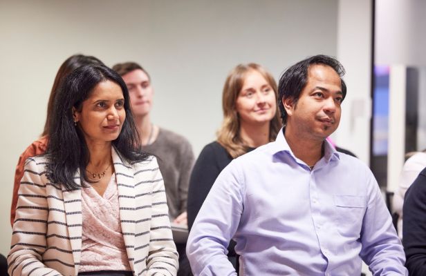 Four male and female team members in a boardroom