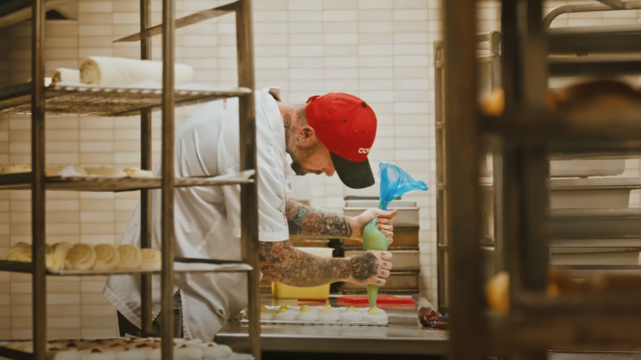 Coles Baker at work icing pastries