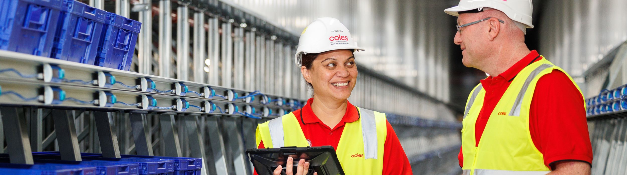Two adc employees talking to each other at the distribution centre