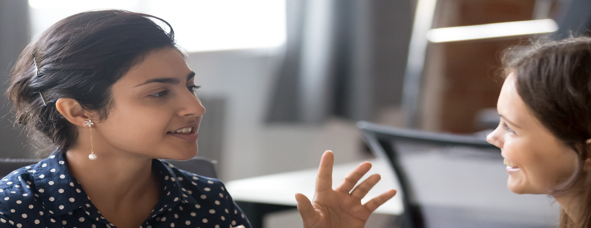 Two women talking in office