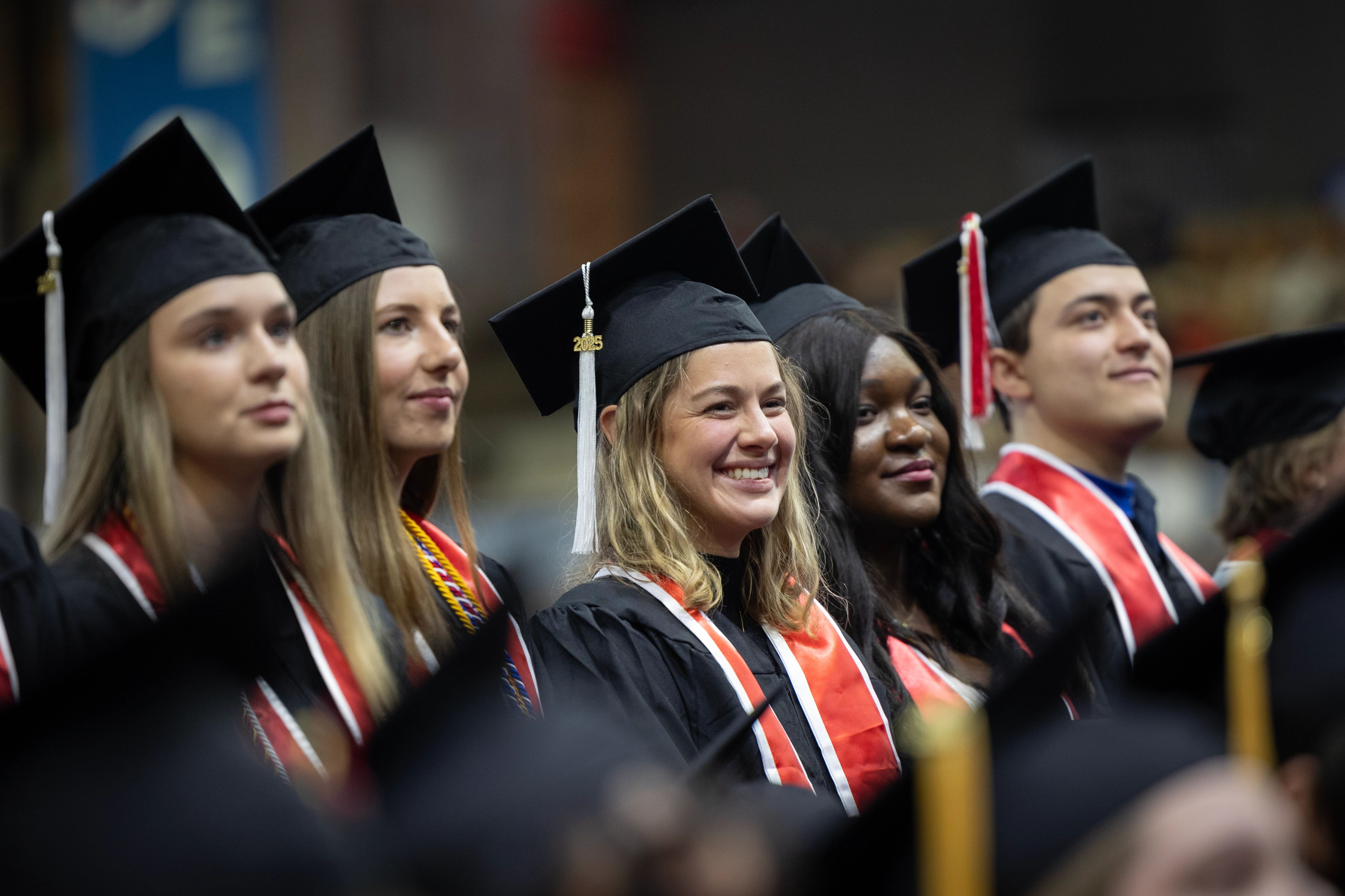 lineup of graduates in caps & gowns