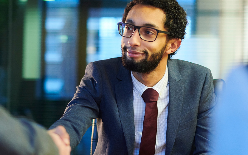 man shaking hands during interview
