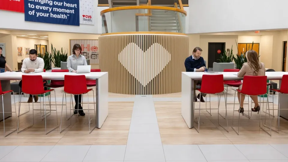 CVS colleagues sitting in an open area with their laptops