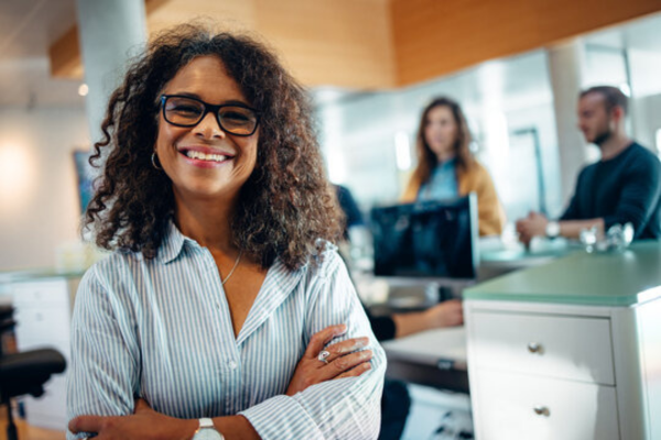 Woman with arms folded smiling 