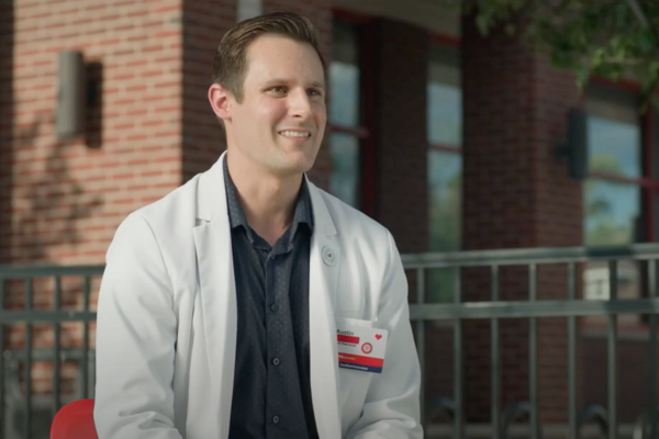 Male pharmacist smiling outside of a CVS Pharmacy location