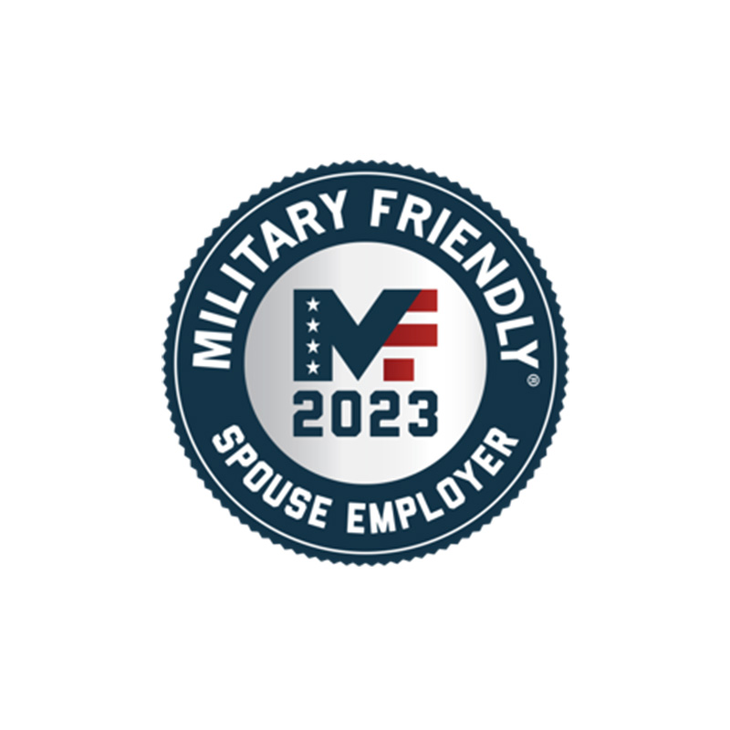 A circular badge with a blue border containing the words "MILITARY FRIENDLY SPOUSE EMPLOYER." In the center, there's the text "MF 2023" featuring an American flag-themed design within the "MF.