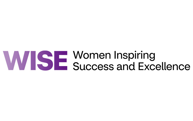 Logo with the acronym WISE in bold purple letters, next to the full name "Women Inspiring Success and Excellence" written in black text on a white background.