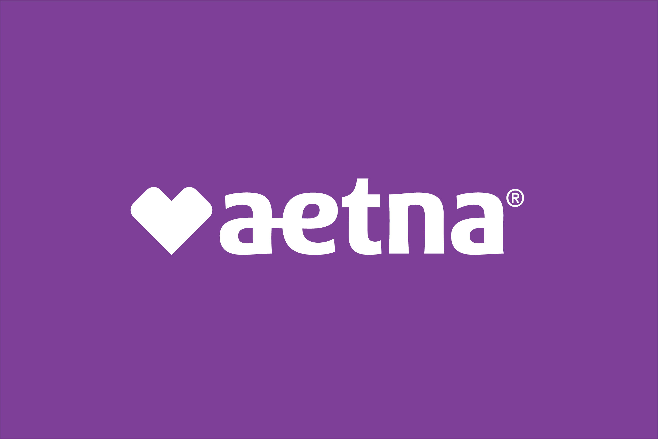 Aetna logo in white text is displayed on a purple background. The word "aetna" is written in lowercase letters with a heart symbol replacing the dot above the letter "i".