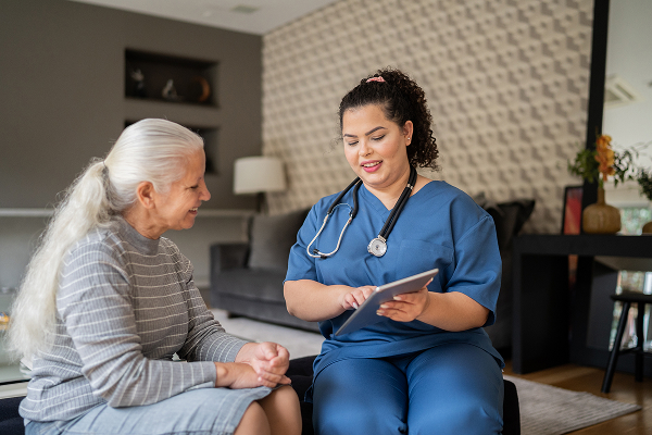 A healthcare professional visiting a patient at home