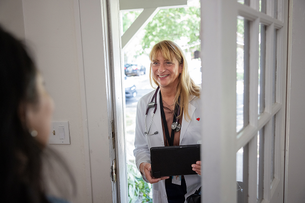 A healthcare professional visiting a patient at home