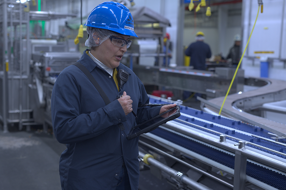 Team members works on a Connected Shop Floor tablet