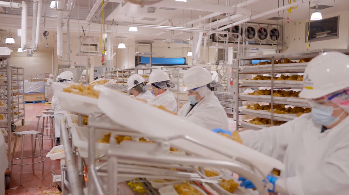 Photo features team at Conagra Fayetteville working the fried chicken line