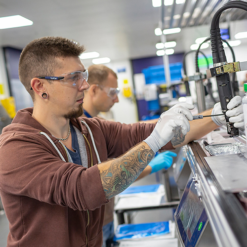 Photograph of LINX associates working in factory