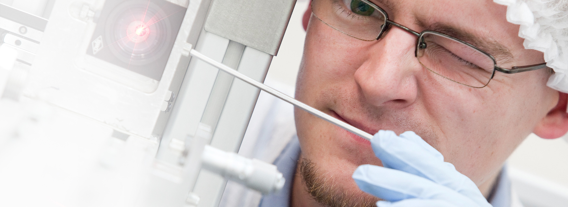 Alltec associate adjusting a laser