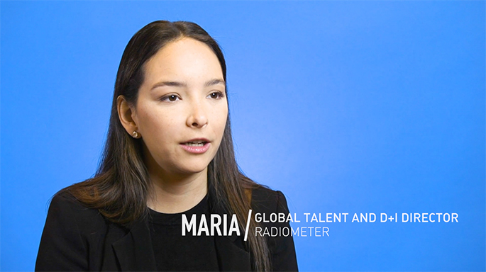 Photograph of Maria in front of blue background