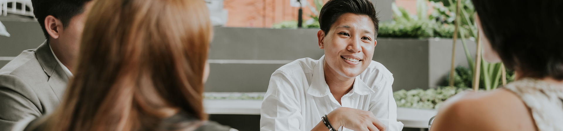 person in a meeting speaking to others