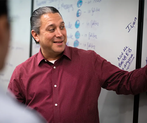 image of eduardo presenting off of a whiteboard