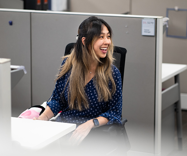 woman sitting in an office chair in a cubical