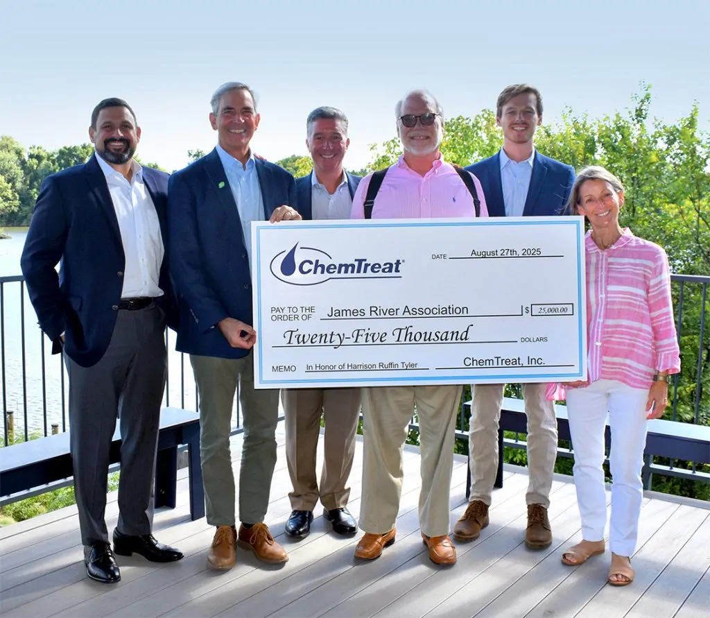 ChemTreat associates smiling and holding a large check for a $25,000 donation to the James River Association from ChemTreat