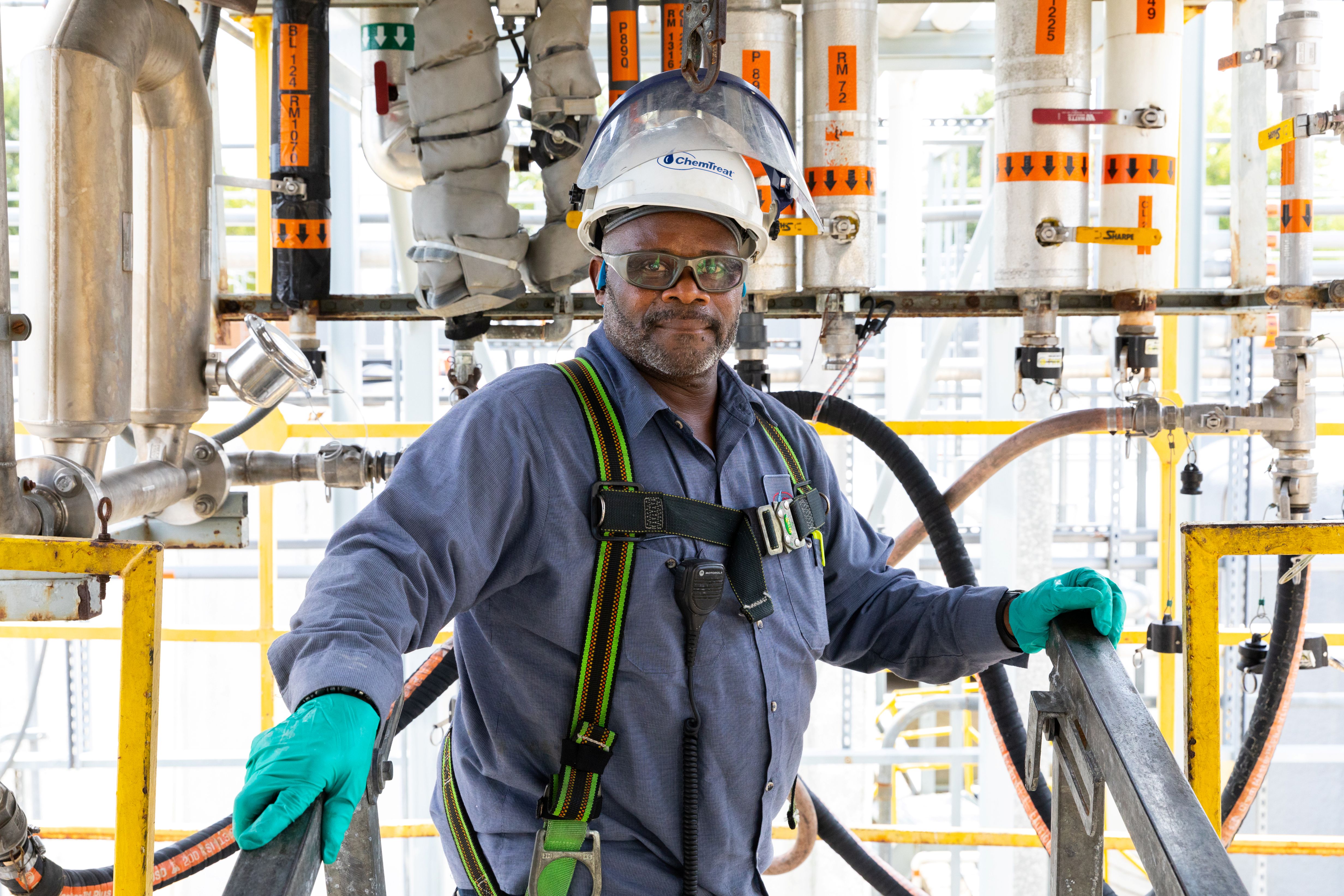 A ChemTreat associate in a hardhat posing at a ChemTreat plant