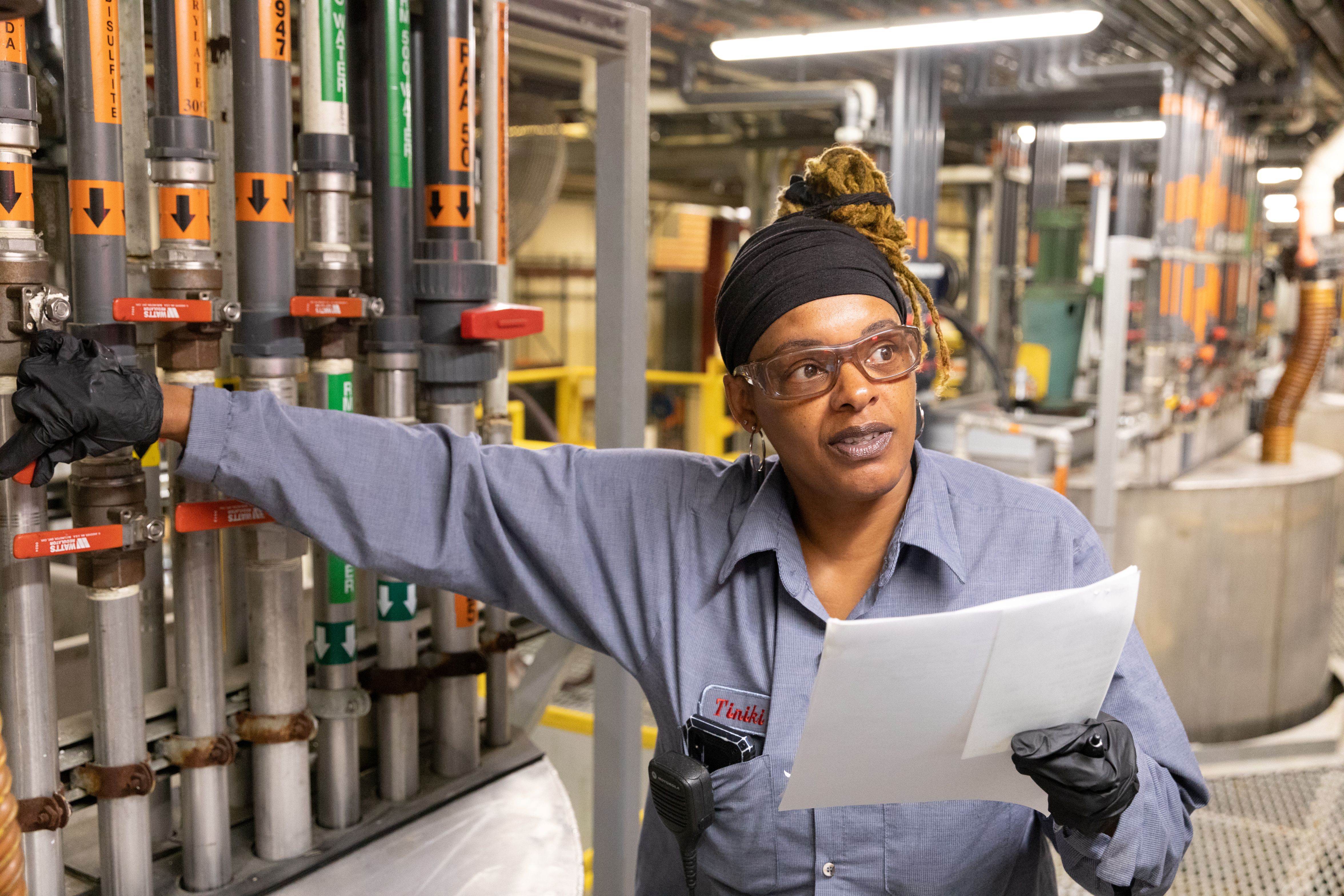 A ChemTreat plant associate pointing out components of products