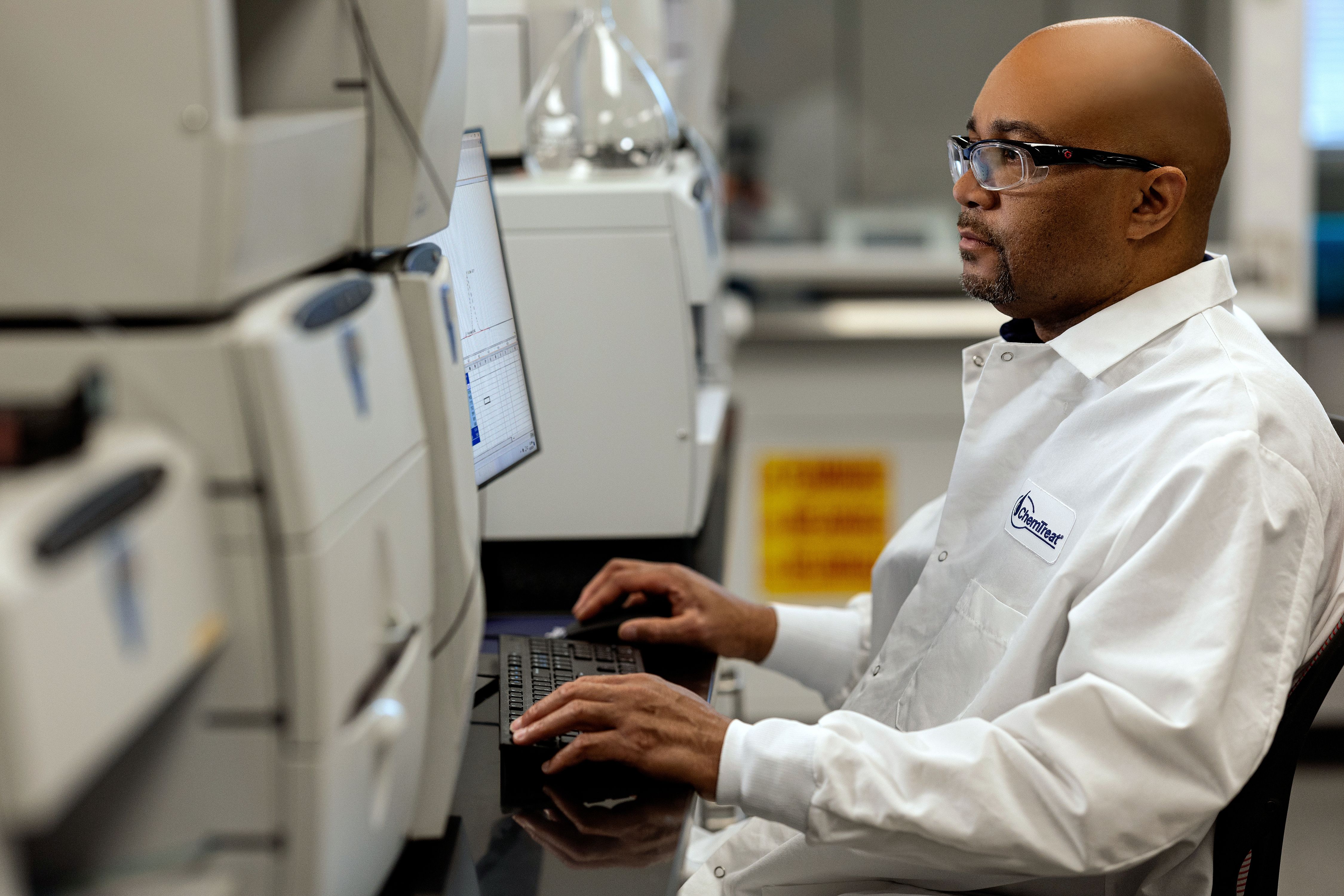 A ChemTreat associate working at a computer in a lab