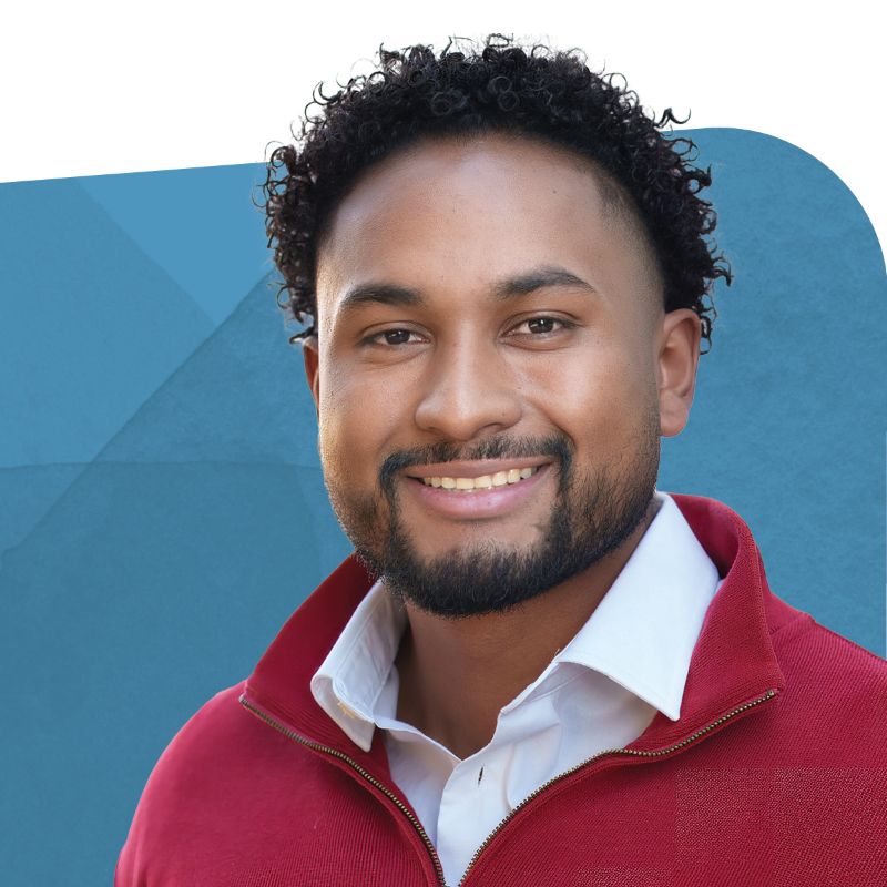 Joe Salinas, Market Intelligence Analyst, smiling against a blue background