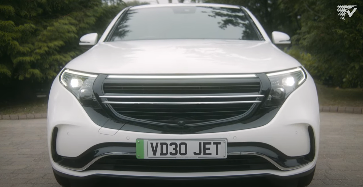 An SUV with a "Videojet" license plate pulling into a driveway