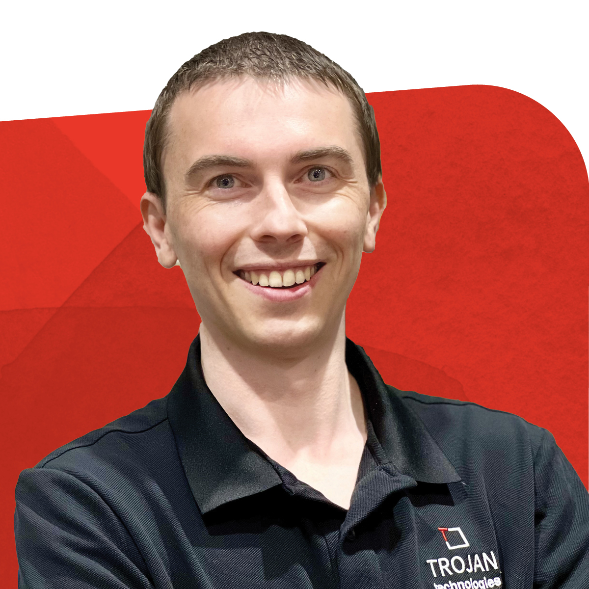 Brandon Scott, Quality Specialist, smiling against a red background 