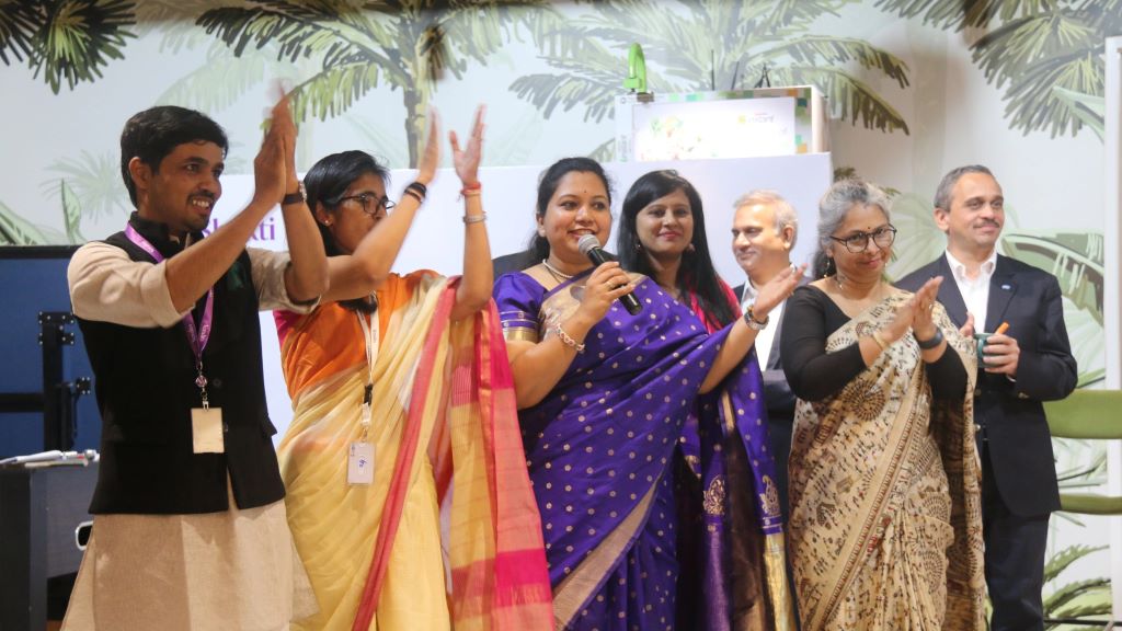 Members of the Shakti ARG smiling and clapping