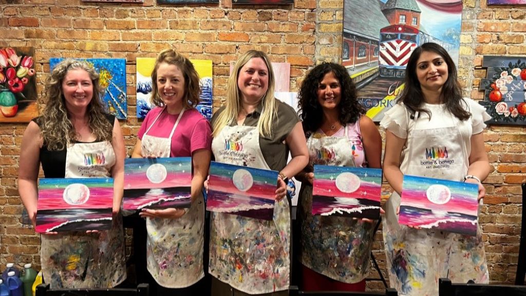 Members of the Women's Inclusion Network posing at a painting activity