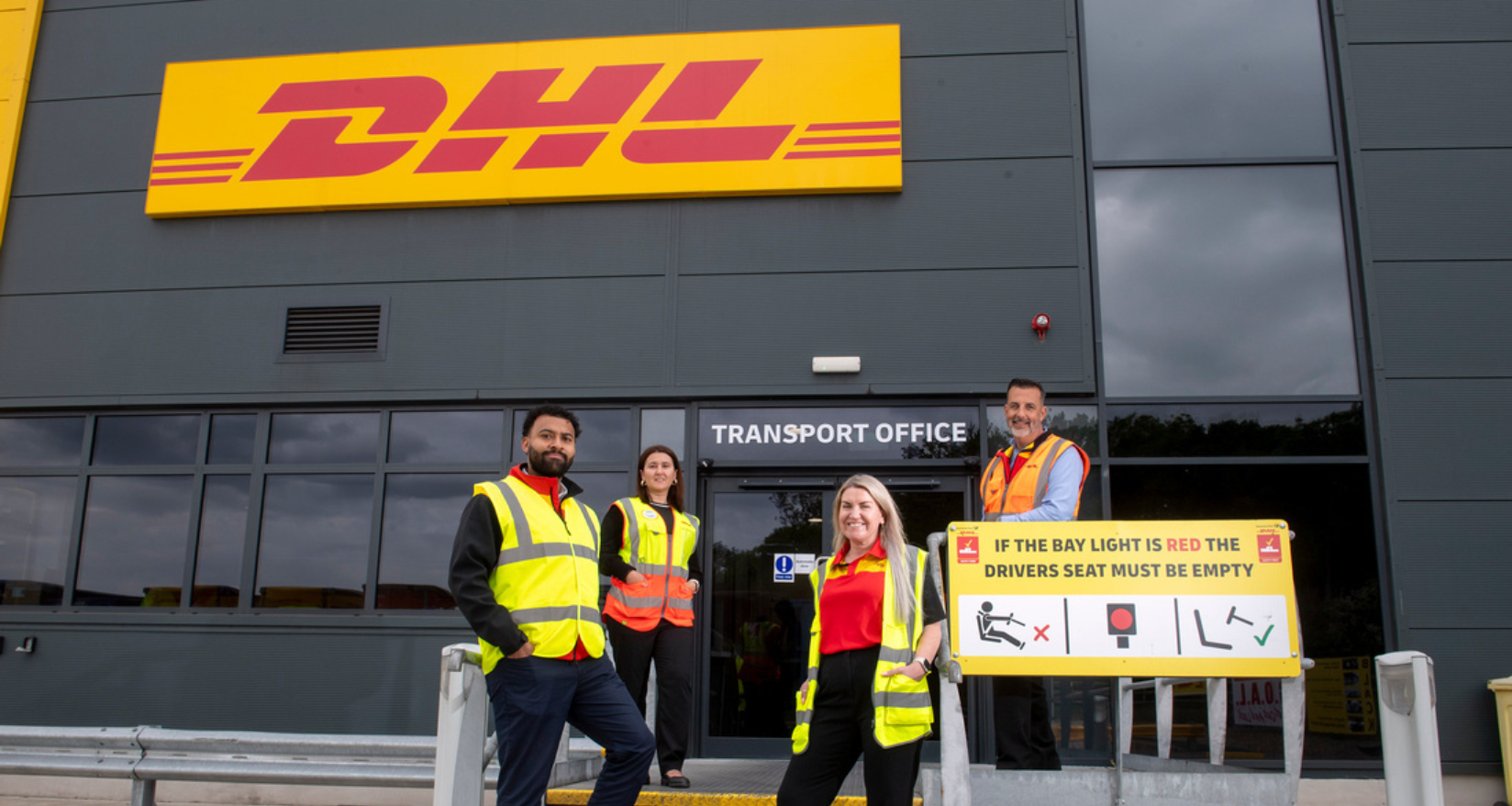 DHL Transport Managers in front of a Transport Office