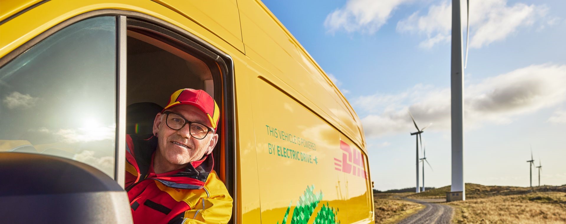 DHL driver driving a DHL EV lorry