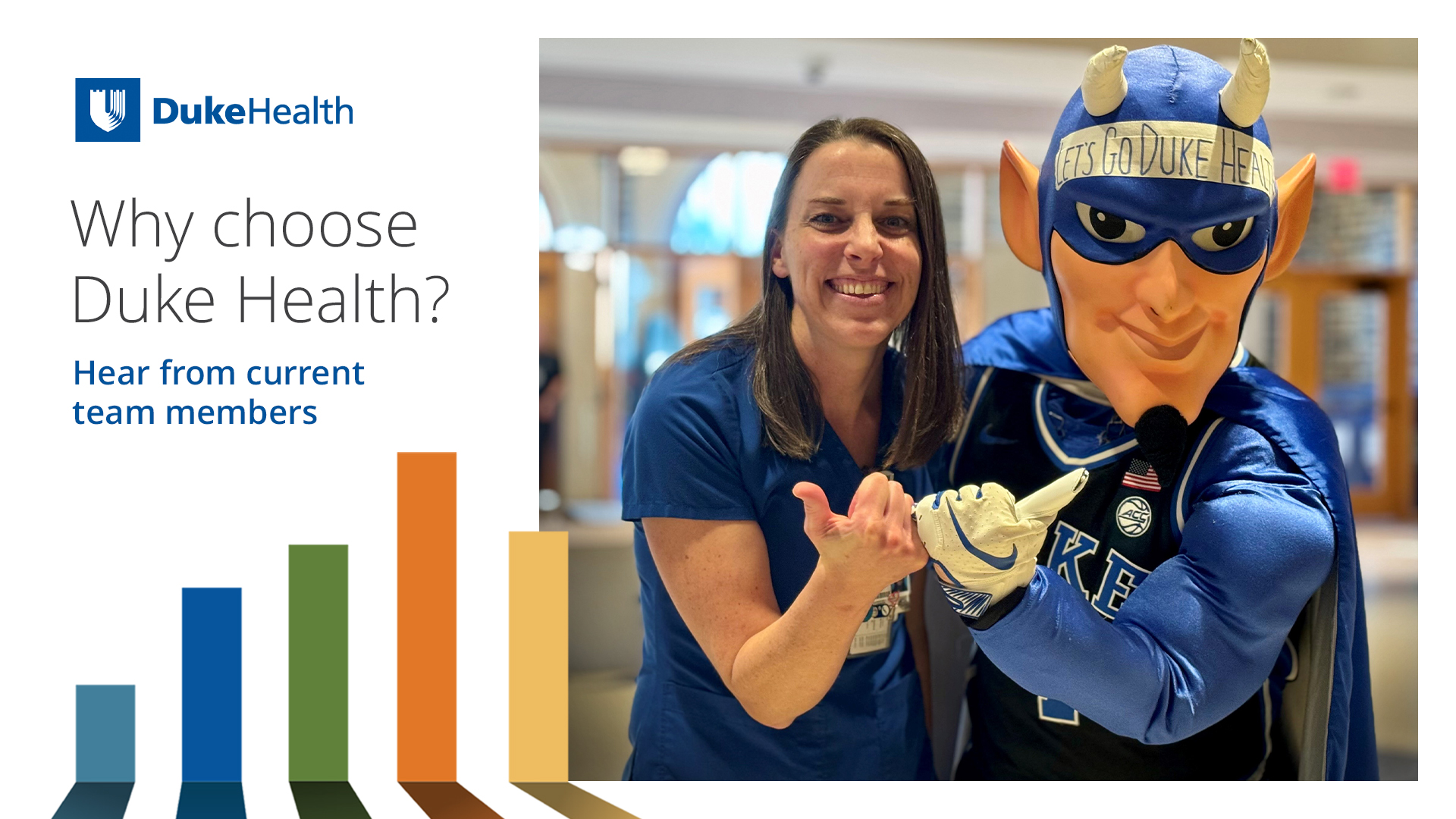 A female nurse in blue scrubs smiles with the Duke blue devil.