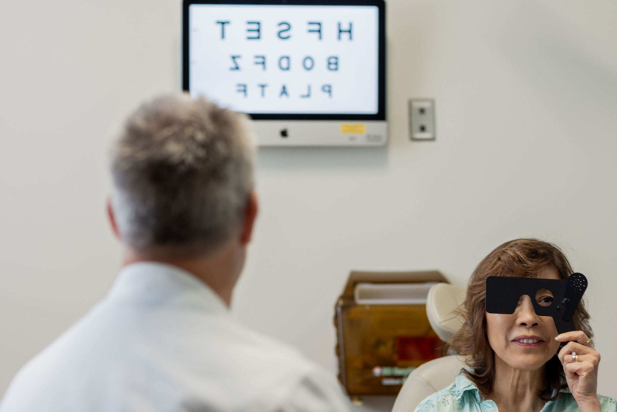 Female takes a vision test at a Duke facility.