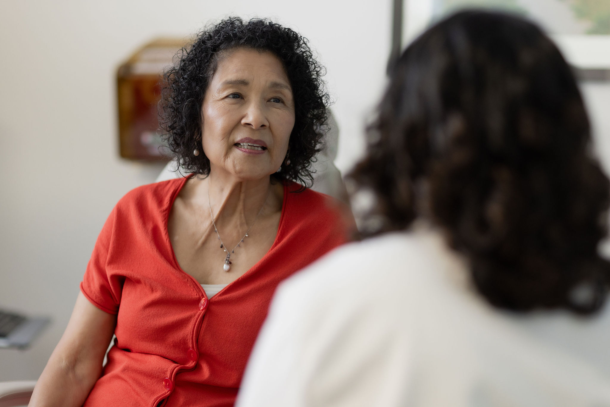 Female talks with a doctor.