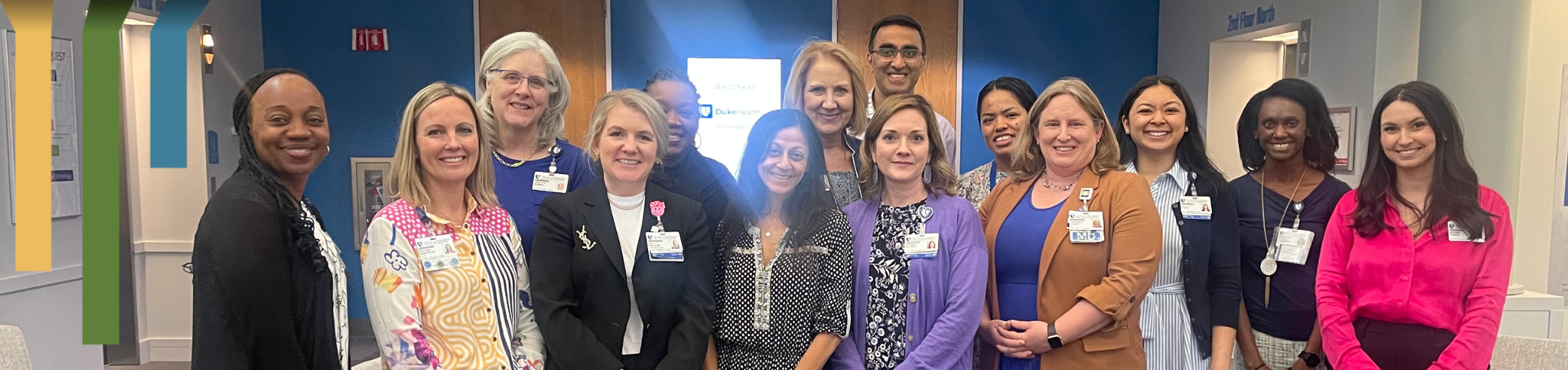 Team members smile together in Duke Health facility.