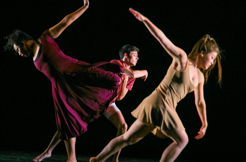 Three dancers perform together. 