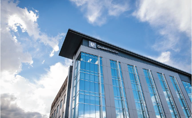 Sunny blue sky over Duke Health building. 